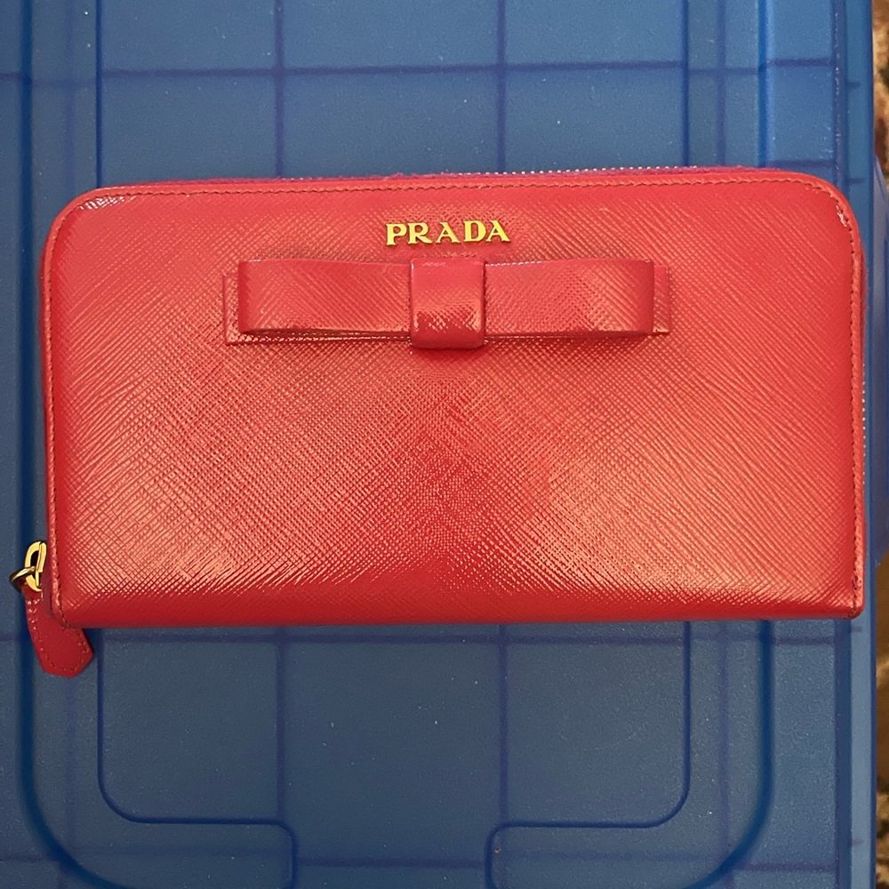 Prada red saffiano leather bow front zip around long wallet